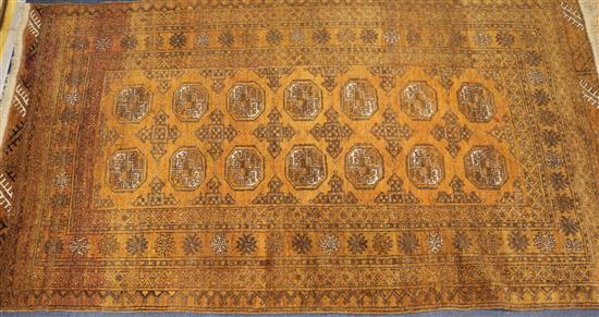 An orange ground Persian rug 200 x 110cm